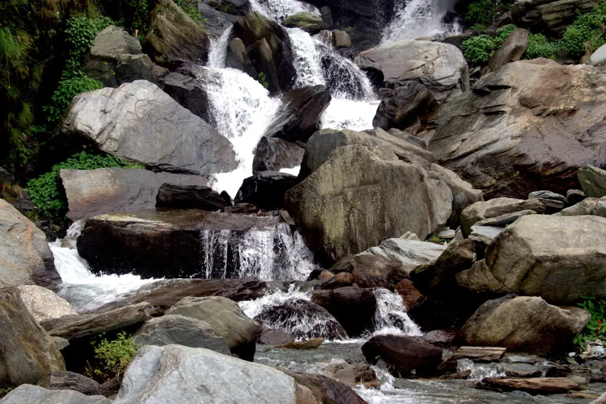 Water tumbling over boulders at Bhagsu waterfall