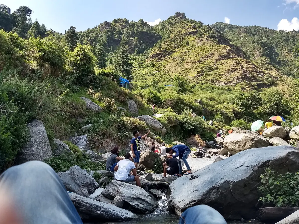 Visitors on the rocks below Bhagsu waterfall